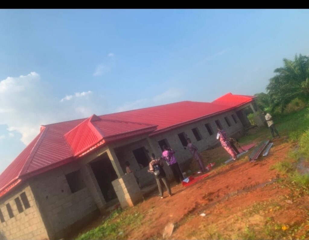 Red aluminium roof installation on a single-story building by Blessed Joe Aluminium.
