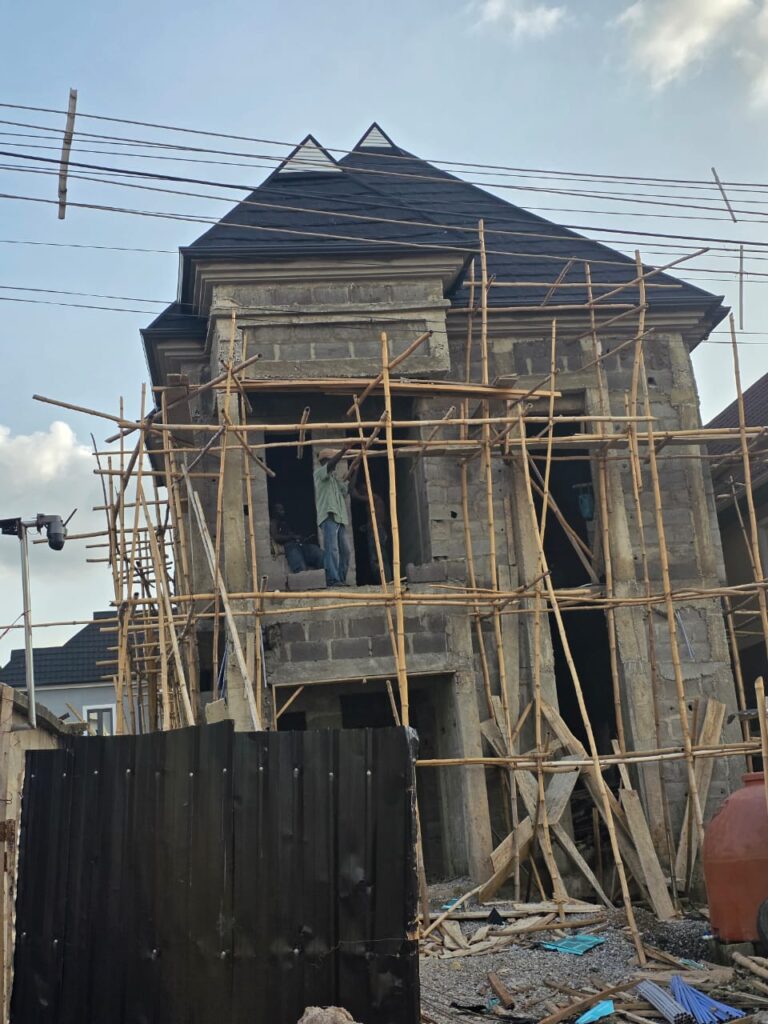 Black aluminium roof on a multi-story building under construction by Blessed Joe Aluminium.
